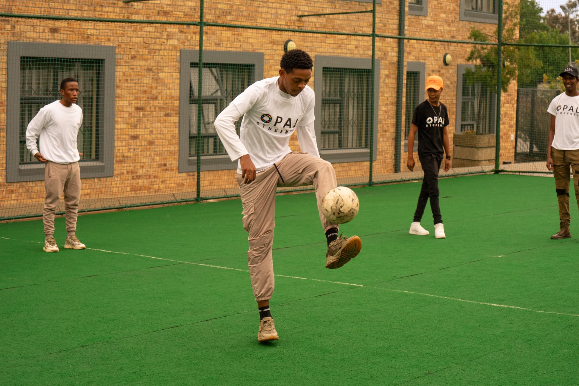 Students playing soccer on the Opal Students astro court