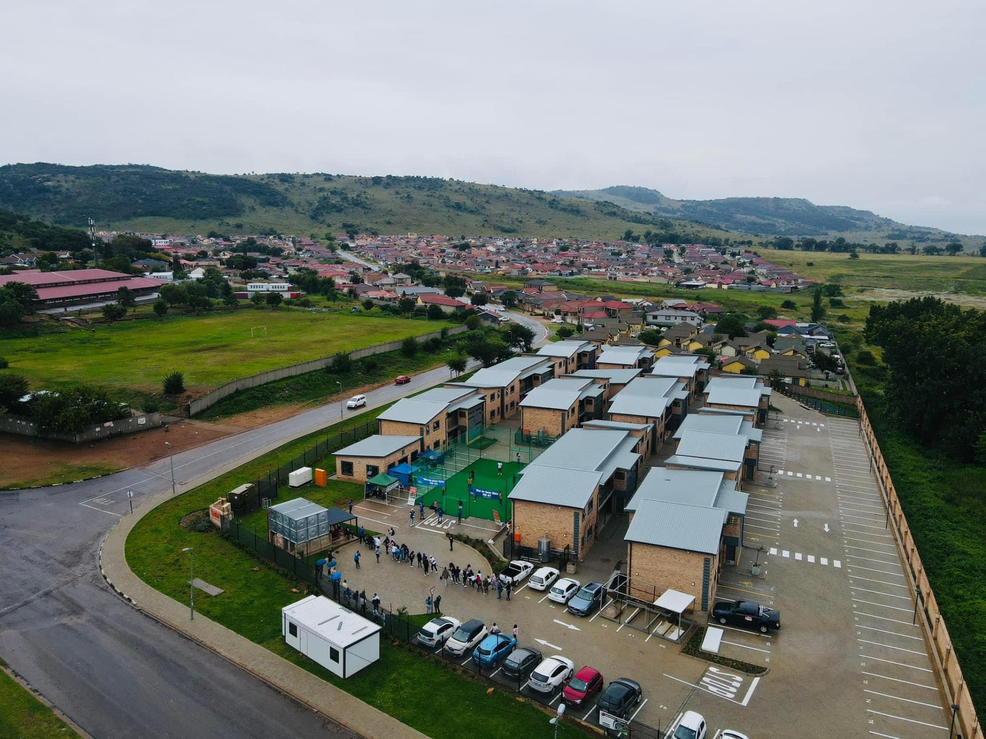 Aerial view of Opal Students Apartments and its parking area